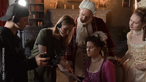 Wallpaper Mural Medium shot of female producer and male cinematographer briefing actors in Victorian period costumes for shooting new scene on historical movie set, demonstrating storyboard on tablet Torontodigital.ca