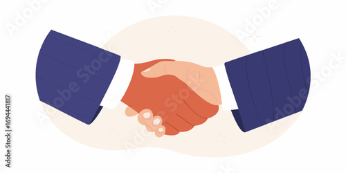 Two business people in suits shaking hands to seal a deal or agreement