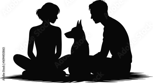 Silhouette of a couple and their dog sitting together outdoors on a grassy area
