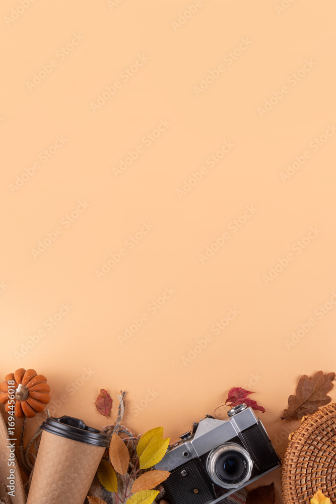 Fototapeta premium Comfortable autumn leisure background with fall decor and photo camera