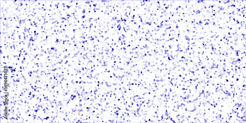 Blue rain drops on a transparent glass window create an abstract liquid texture with light and bubbles