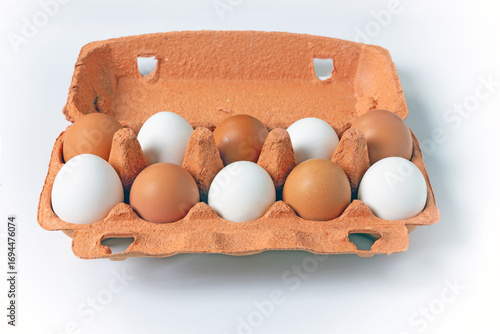 Raw Eggs in Сardboard Сontainer on White Background.