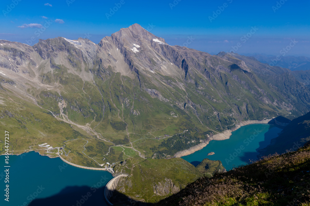 Fototapeta premium Mooserboden Staudamm in Austria beautiful alpine lakes stunning landscape. Austrian Alps in Salzburg Kaprun hiking trail scenic photo of two mountain lakes with turquoise water in the Alps from above