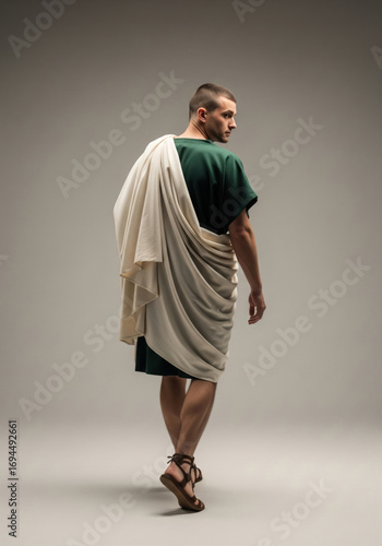 Ancient Roman man in green tunic with draped white toga, back view