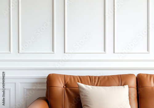 Scandinavian home interior design of modern living room. Brown leather sofa near white paneling wall, interior background with copy space.