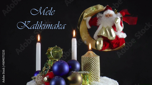 Warm Wishes for Christmas Joy 
A festive card with candles, baubles, and Santa Claus in the language Hawaiian 
