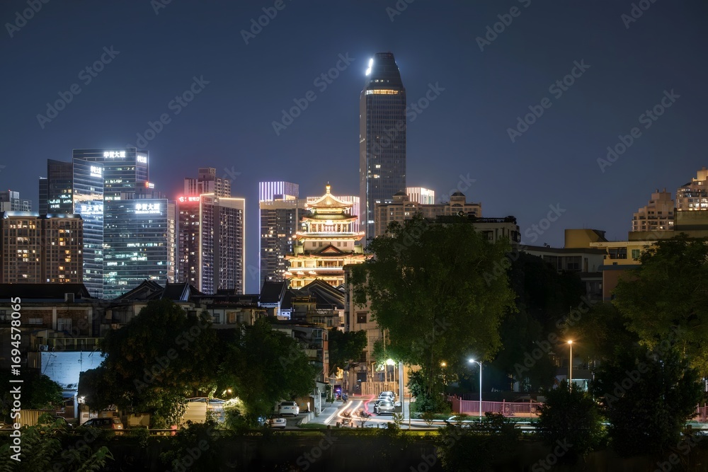 Obraz premium Modern cityscape with traditional pagoda tower illuminated at twilight blue hour urban skyline