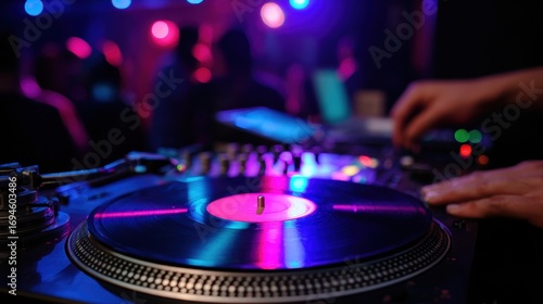 DJ Mixing Music on Turntable at Nightclub with Purple and Blue Lighting