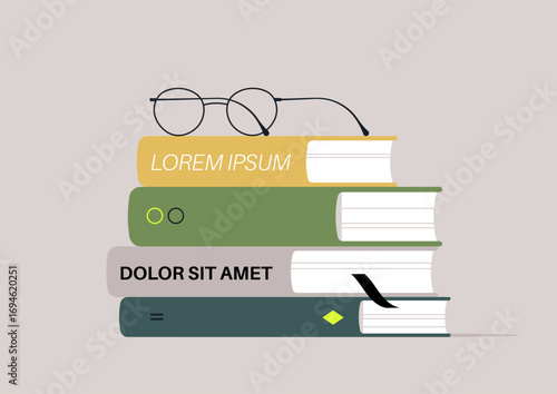A vibrant assortment of five meticulously arranged books showcases their unique covers, with a pair of glasses placed neatly on top, suggesting a love for reading and learning