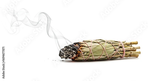 Burning sage bundle emits swirling smoke against a white background
