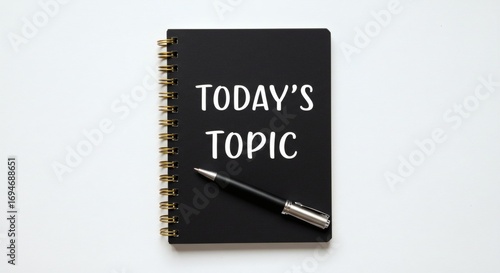 Todays Topic Black Notebook  Pen on White.