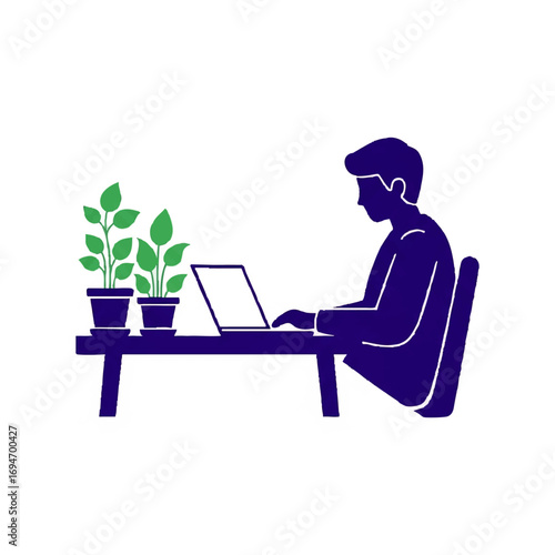 Modern professional working diligently on laptop at desk with plants, creative workspace concept