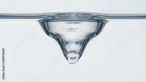 Side-view macro video of rising air bubble in viscous glycerin