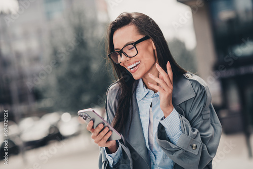 Urban businesswoman with elegant style enjoys leisure time outdoors in the city during a casual spring day