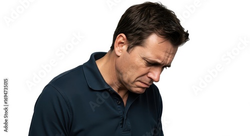 A man with a somber expression, looking downward, conveys a feeling of dejection against a plain white background.