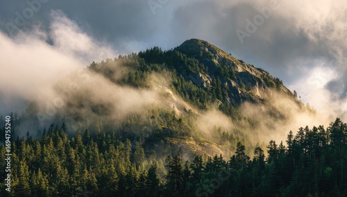 Mountain peak emerging from a veil of clouds