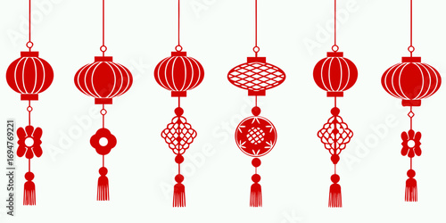 Collection of traditional red chinese lanterns and decorative ornaments hanging against a white background