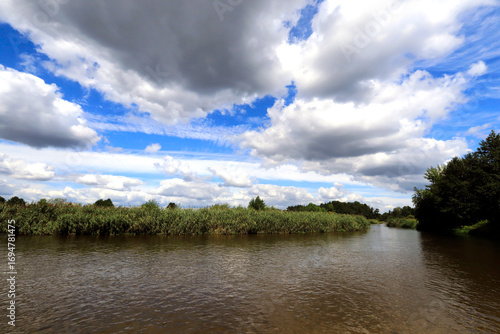 Pilica River between the bridges clouds over the river
