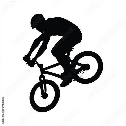 Silhouette of a cyclist performing a trick on a bicycle