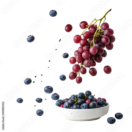 A bowl of blueberries sits beneath a cluster of red grapes, isolated on transparent background, creating a vibrant contrast of colors and textures