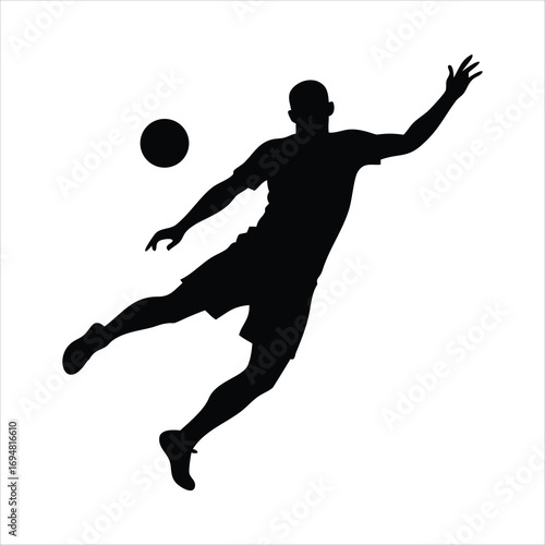 Silhouette of a soccer player kicking a ball in mid air