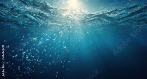Underwater sunlight beams through rippling water