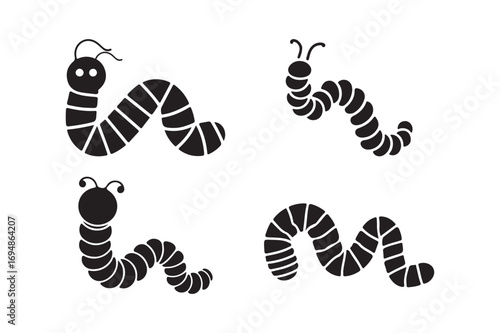 Four black silhouettes of wiggling caterpillars on a white background