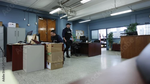 Wide shot of police precinct with officers