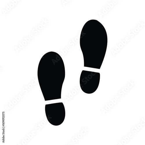Two black footprints on a white background indicating the direction of travel