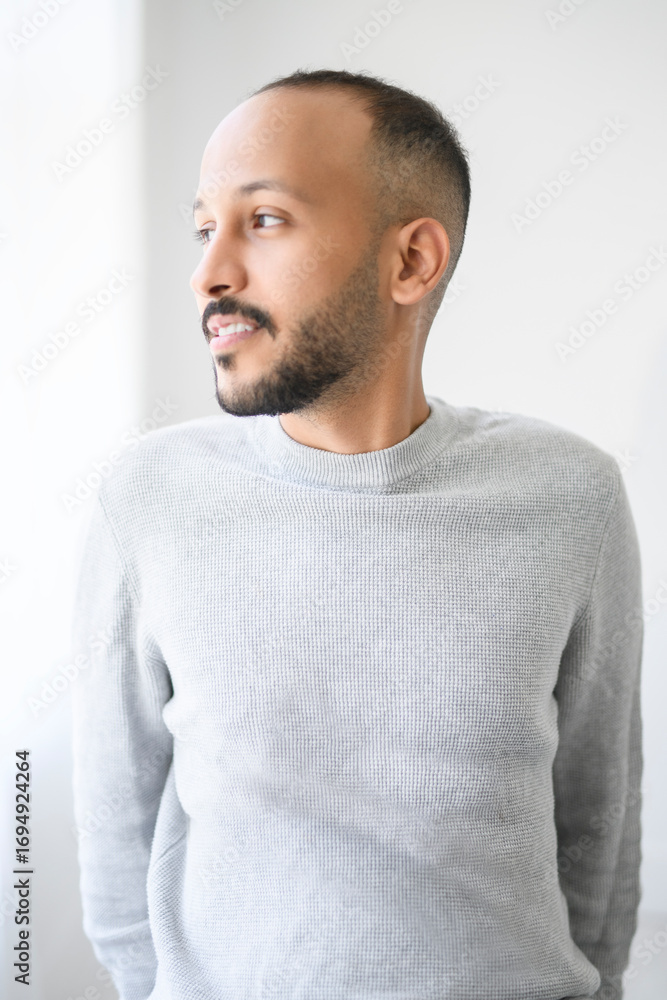 Fototapeta premium young islamic arab man against white studio wall