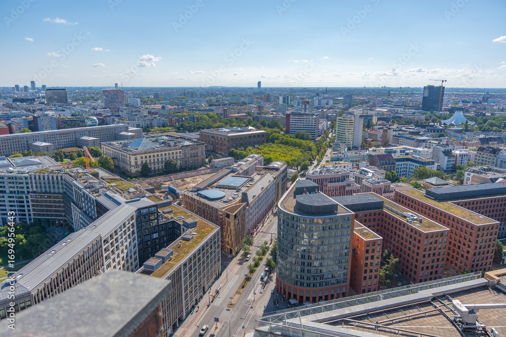 Fototapeta premium City panorama of Berlin with streets, buildings, and parks. The view stretches far to the horizon.