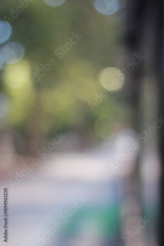 A dreamy view of a sidewalk in a city neighborhood.