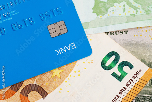 Credit card laying on top of  the cash of money