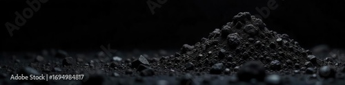 Close-up shot of dark, textured fossil fuel against a stark black background, highlighting its raw, organic nature and emphasizing its impact on the environment , carbon, crude oil