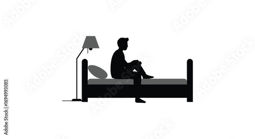 a person sitting on bed with lamp beside silhouette