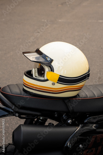 Vintage Motorcycle Helmet Resting on a Bike Seat