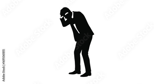 a man in suit covering face with hand standing alone