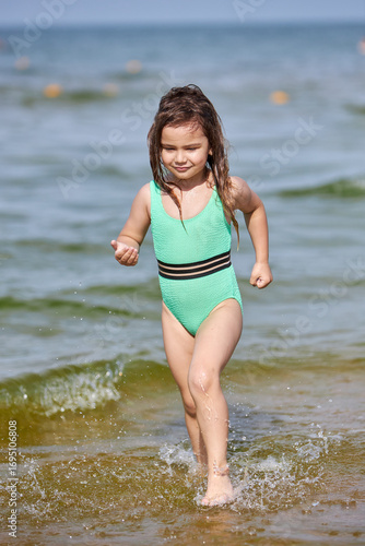 Wallpaper Mural Girl playing in water on a sunny day Torontodigital.ca