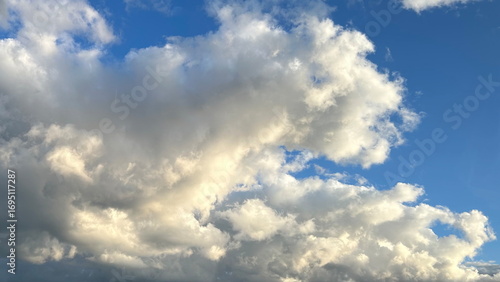 Blue Sky With Big Fluffy Clouds At Golden Hour