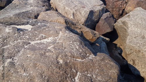 Photos Riprap stones installed along the beach form a dike to hold back ocean waves