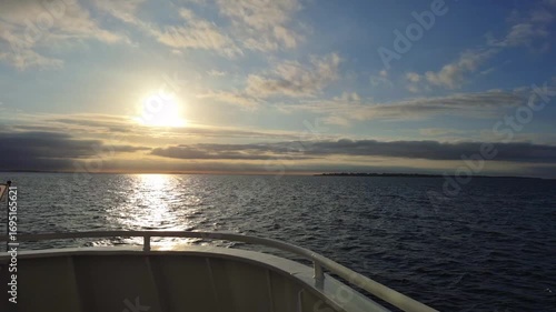 Witnessing a Serene and Beautiful Sunset Over Calm Water While Relaxing on a Boat