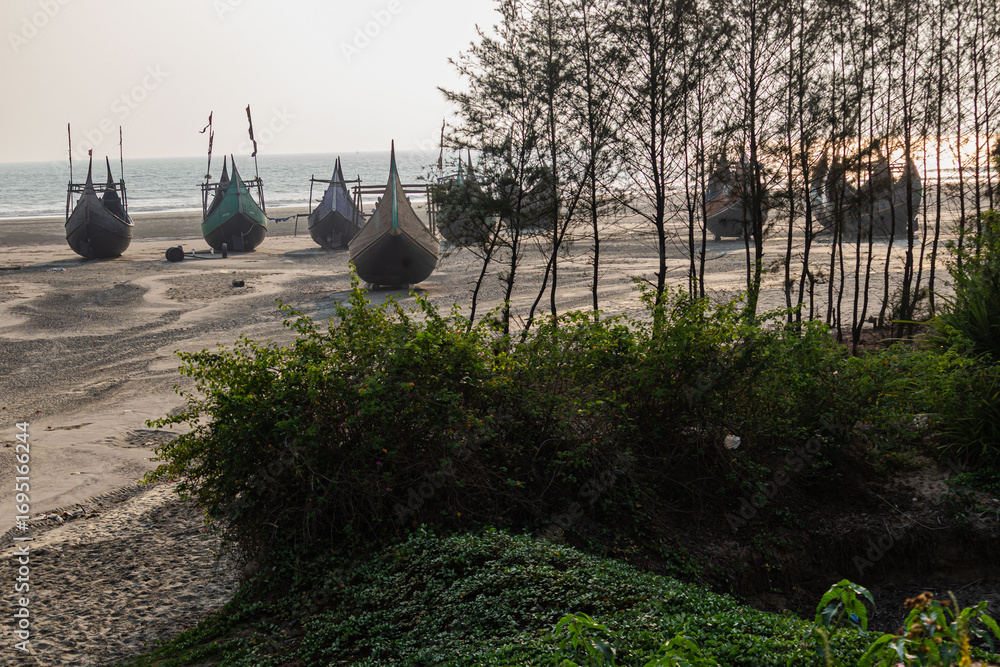 Φωτογραφία Weathered wooden fishing boats waiting patiently for tides on serene Cox’s Bazar beach horizon view