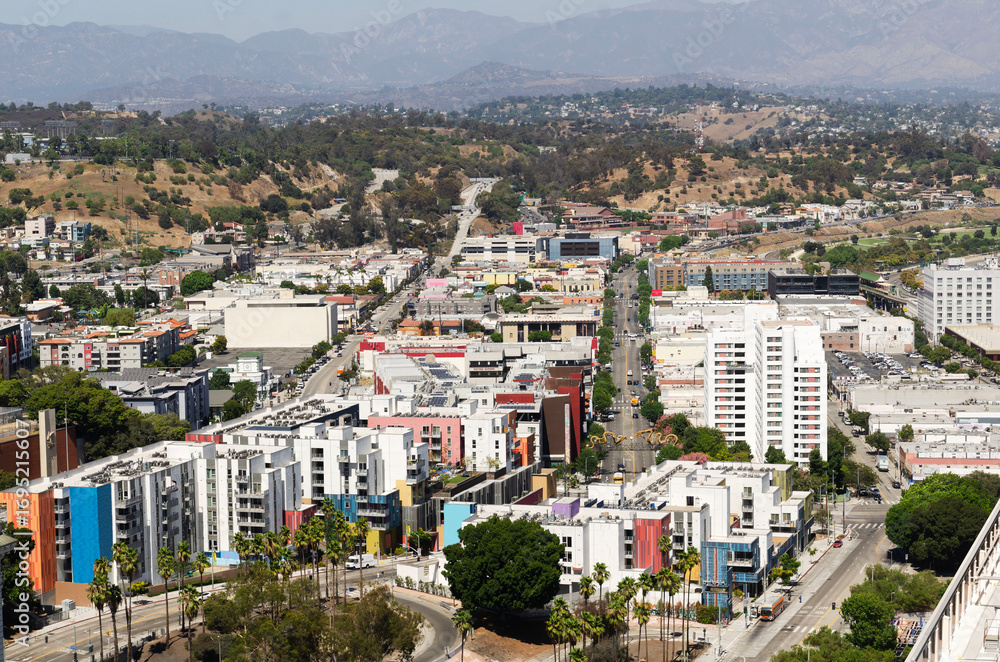 Fototapeta premium California Los Angeles September 4, 2025 Panoramic view of Downtown Los Angeles with houses, mountains and clouds on clear sunny day in California
