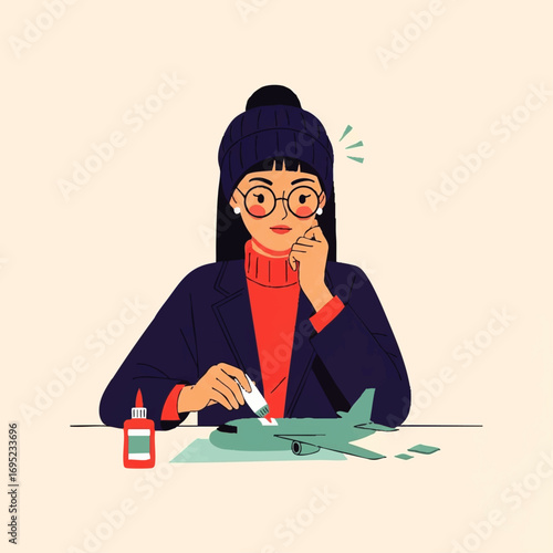 Young woman focused on assembling a model airplane with glue.