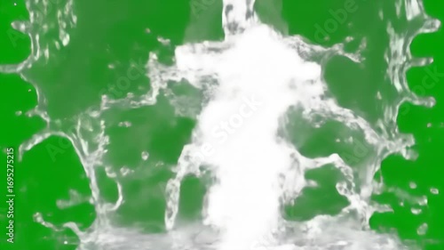 Crystal clear water splashes and pours dramatically, creating dynamic fluid motion against a solid green chroma key backdrop, perfect for compositing.