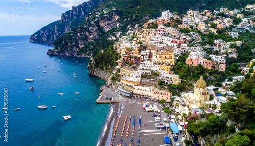Coastal town nestled against a dramatic hillside overlooking a tranquil ocean