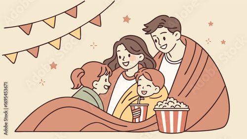 Family enjoying a movie night together under a blanket with popcorn