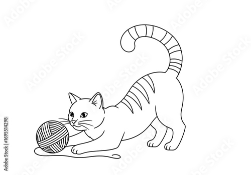 A playful kitten engaged in a fun game with a ball of yarn its favorite pastime