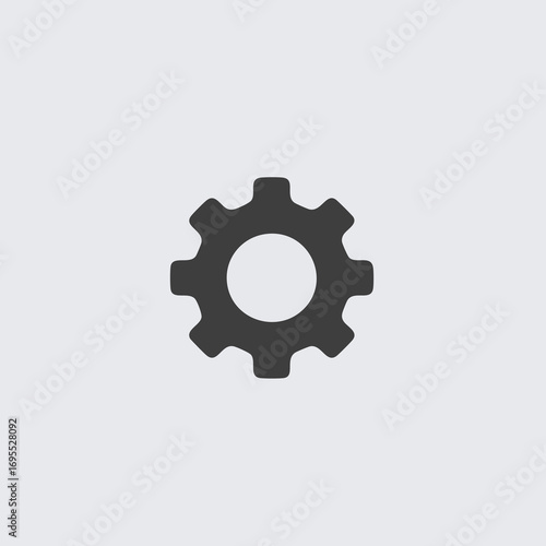 A simple, dark grey gear or cogwheel icon isolated on a plain light grey background.