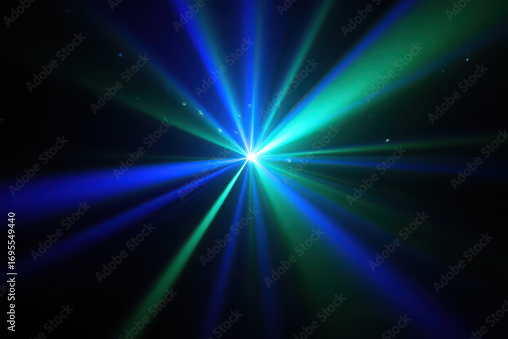 Fototapeta premium Bright blue and green laser light beams emanating from a central starburst on a